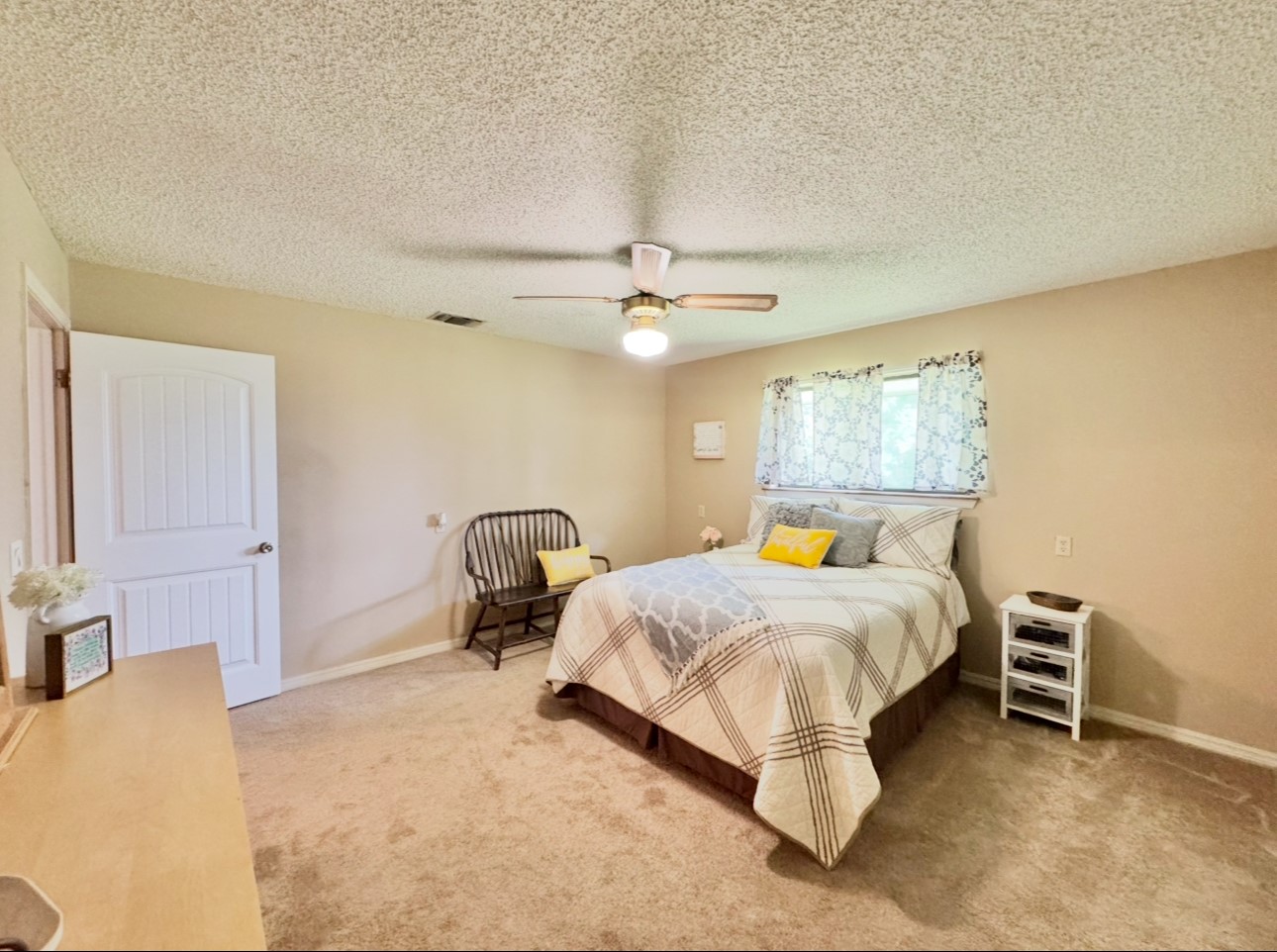 702 Pleasant Grove Road Elgin, TX 78621 - Photo 27 of 38 Carpeted bedroom featuring a ceiling fan and a textured ceiling