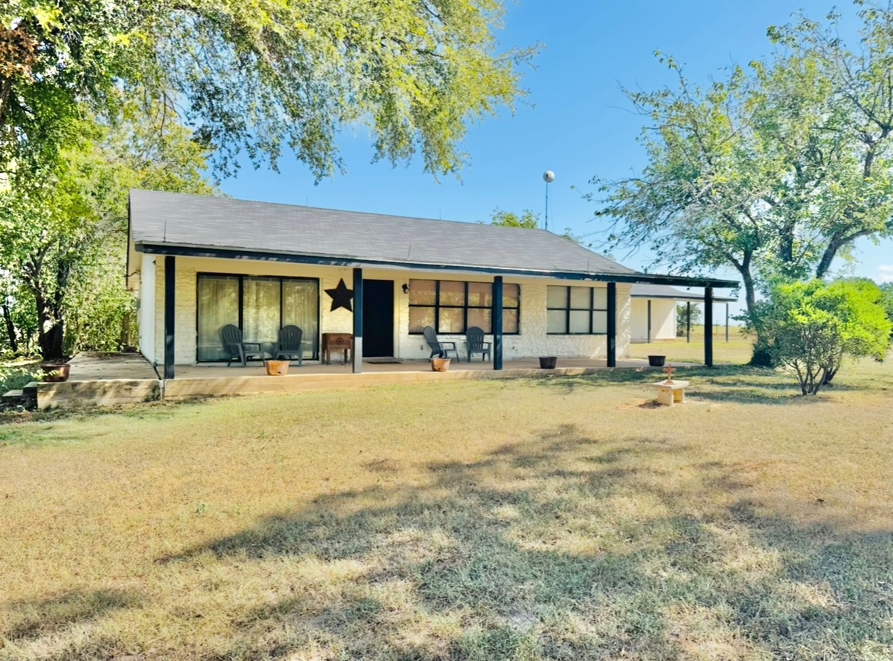 702 Pleasant Grove Road Elgin, TX 78621 - Photo 3 of 38 Front view of house featuring covered porch and a yard