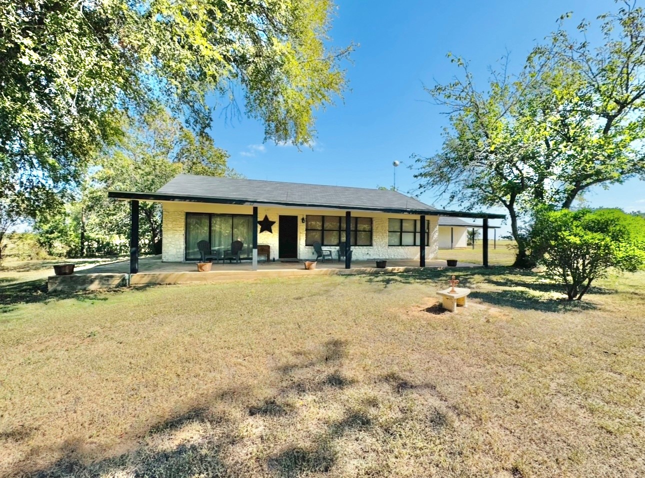 702 Pleasant Grove Road Elgin, TX 78621 - Photo 38 of 38 Front of house featuring a yard and a porch