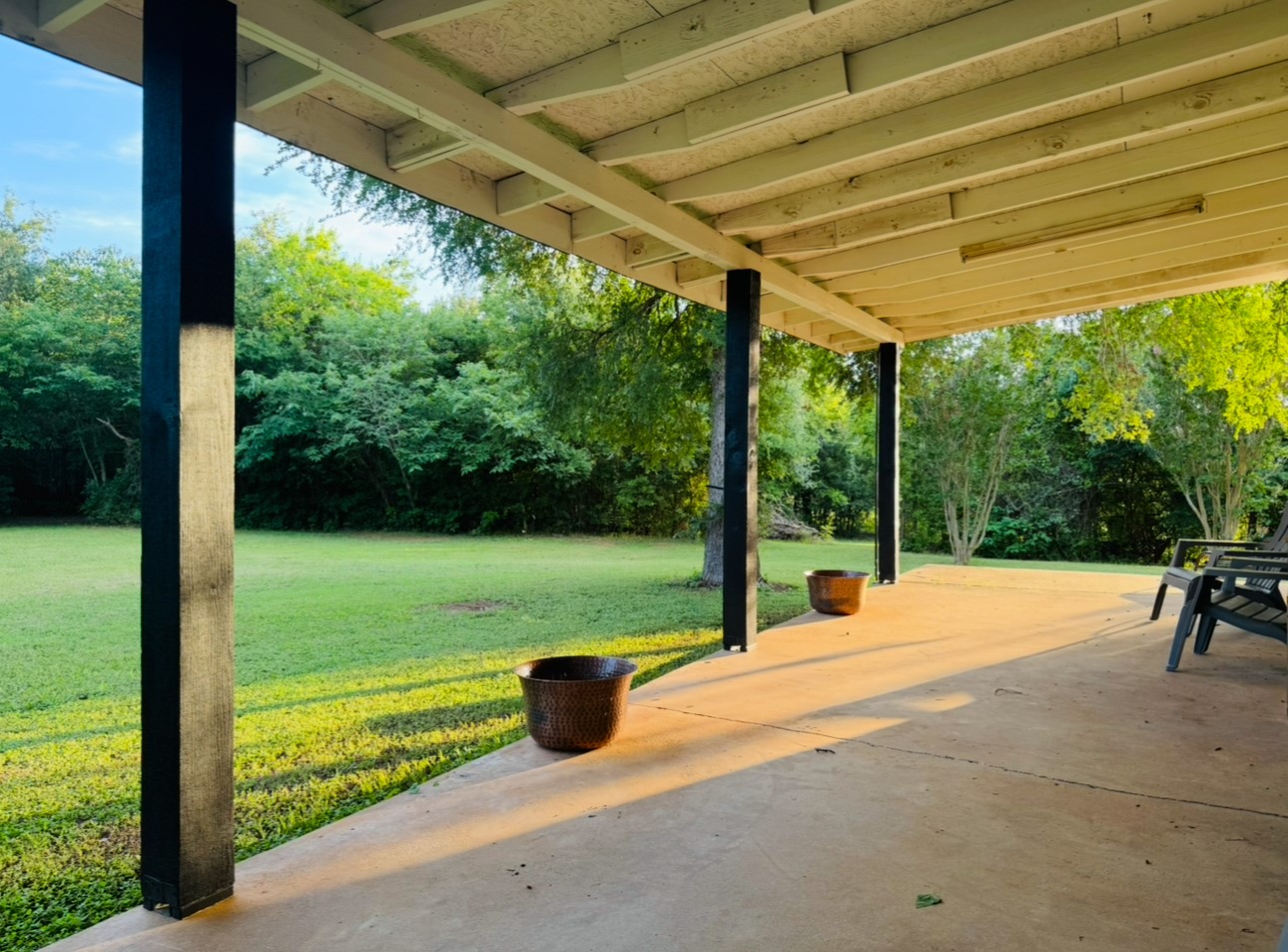 702 Pleasant Grove Road Elgin, TX 78621 - Photo 9 of 38 View of patio / terrace featuring view of scattered trees