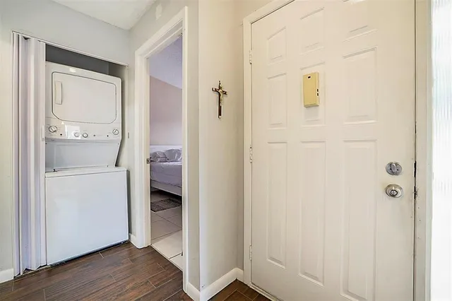 a bathroom with a walk in closet and wooden floor