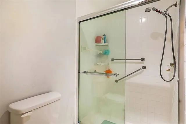 a bathroom with a shower and a mirror