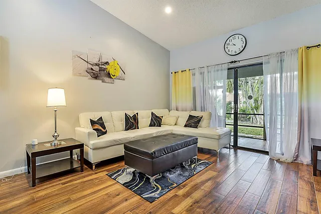 a living room with a bed furniture and a window