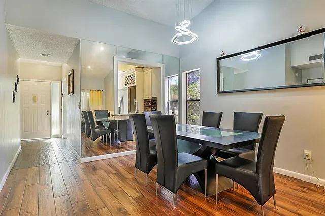 a view of a dining room with furniture and wooden floor