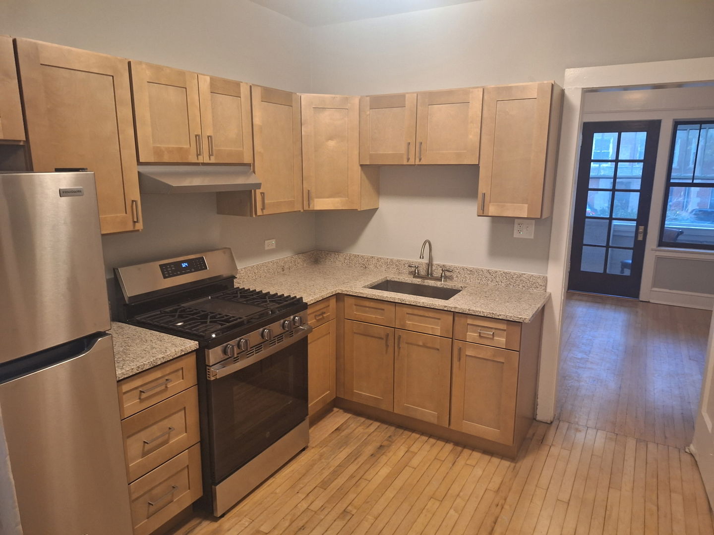 7077 North Ridge Boulevard, Unit 1S Chicago, IL 60645 - Photo 5 of 17 a kitchen with stainless steel appliances granite countertop a stove a sink dishwasher and a refrigerator