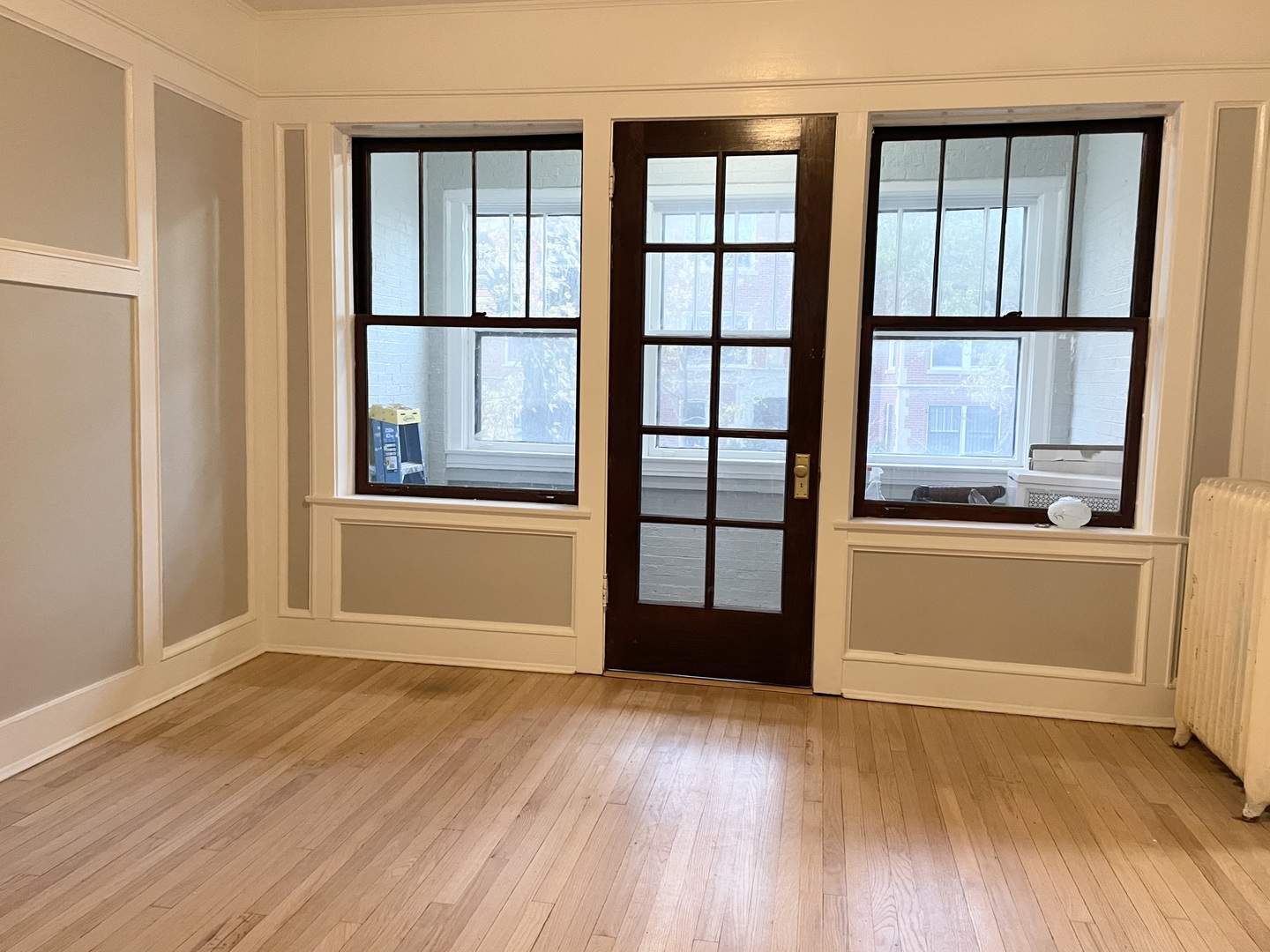 7077 North Ridge Boulevard, Unit 1S Chicago, IL 60645 - Photo 7 of 17 an empty room with wooden floor and windows