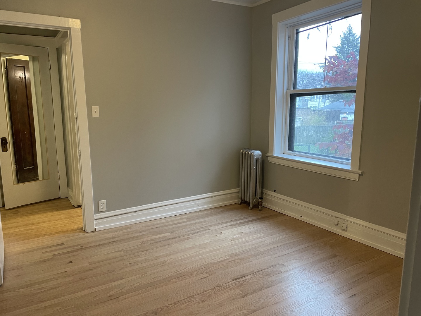 7077 North Ridge Boulevard, Unit 1S Chicago, IL 60645 - Photo 10 of 17 an empty room with wooden floor and windows