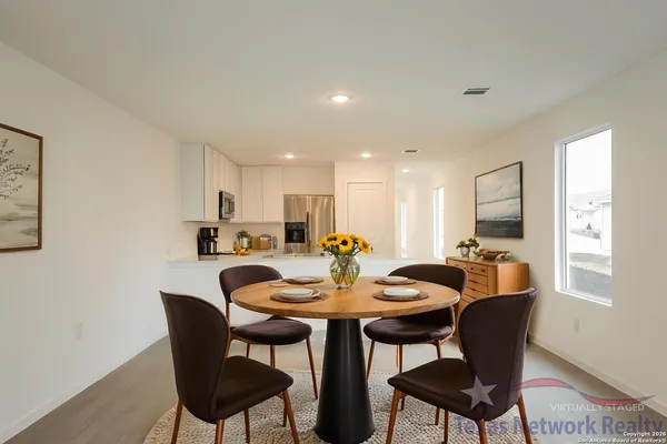a view of a dining room with furniture and window