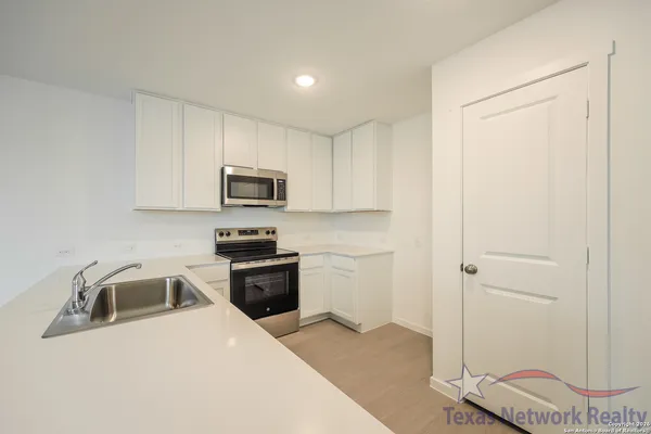 a kitchen with a sink and a stove top oven