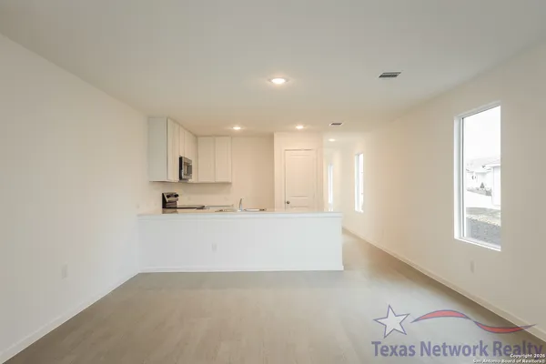 a view of kitchen with wooden floor and windows