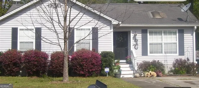 a front view of a house with garden
