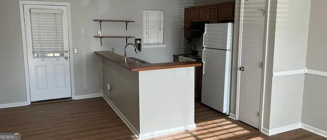 a view of hallway with wooden floor