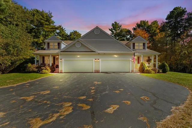 a view of a house with a yard and garage