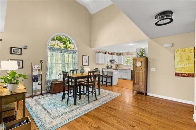 a view of a dining room and livingroom with furniture window and wooden floor