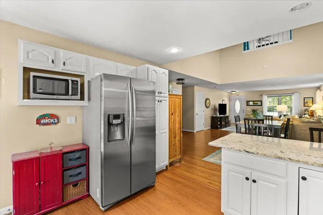 a kitchen with stainless steel appliances granite countertop a refrigerator and a stove top oven