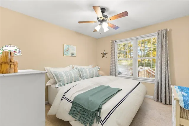 a bed sitting in a bedroom next to a window