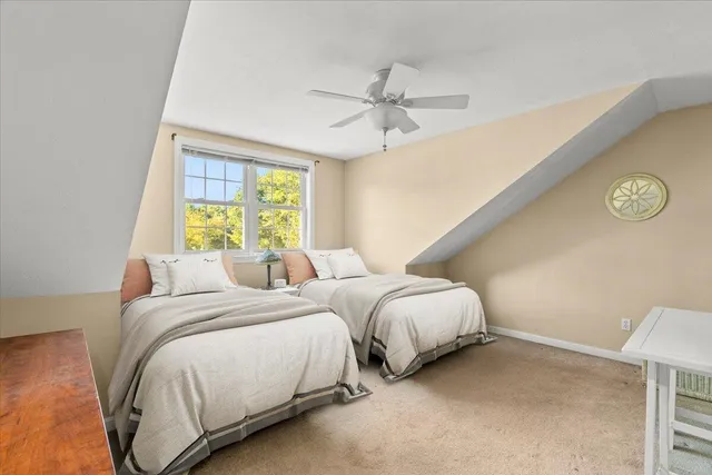 a bedroom with two beds and a window