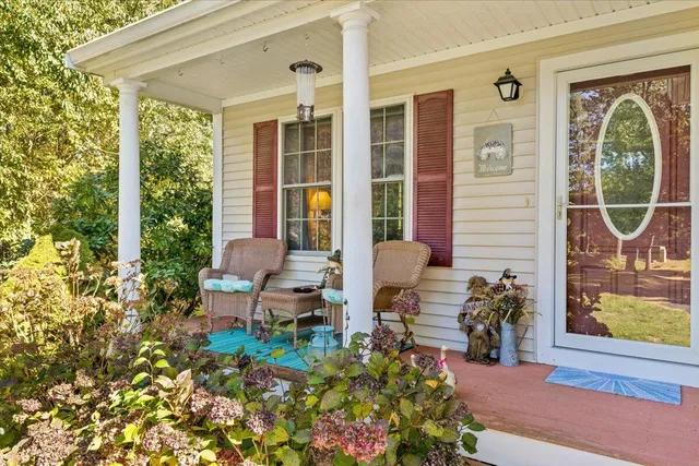 a front view of a house with outdoor seating