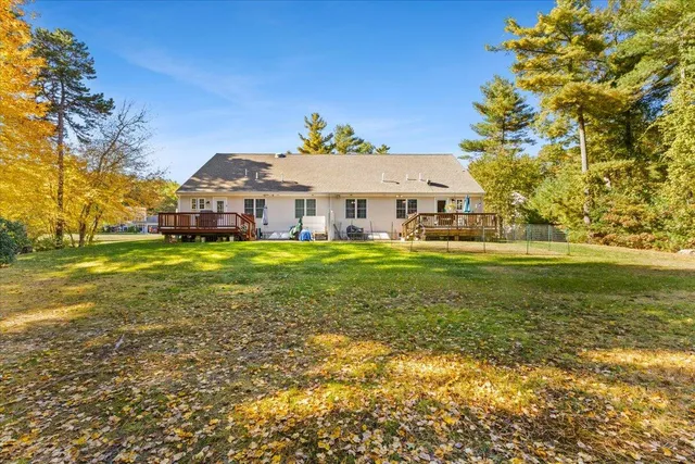 a view of a house with a yard and sitting area