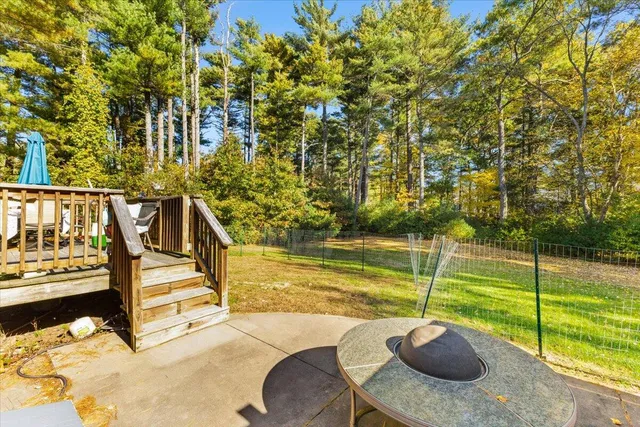 a view of a swimming pool with a patio and a yard