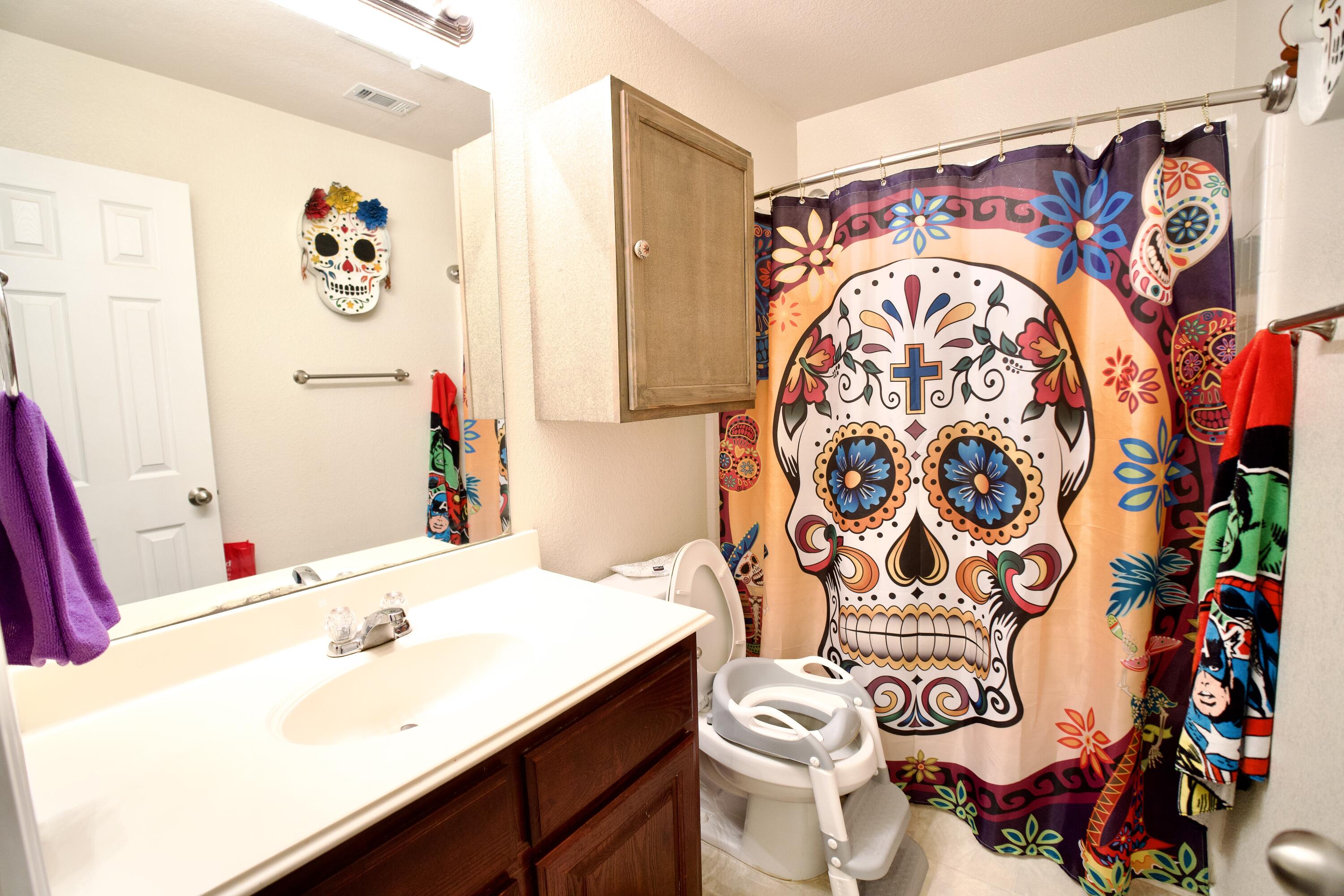 8811 16th Street Lubbock, TX 79416 - Photo 4 of 17 a bathroom with a sink and mirror with toilet