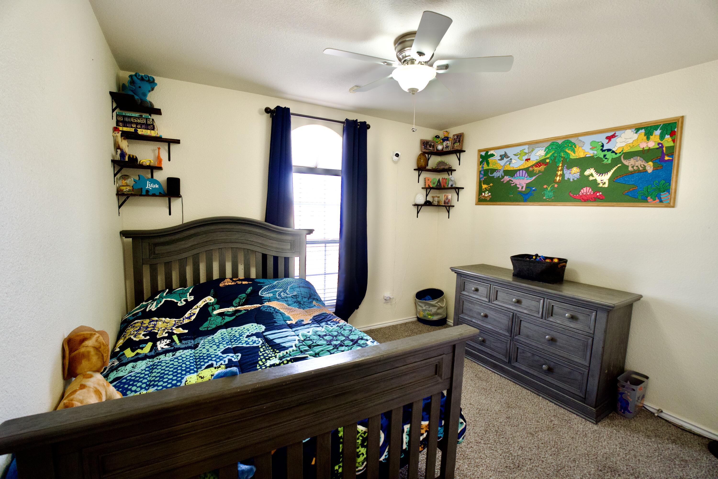 8811 16th Street Lubbock, TX 79416 - Photo 5 of 17 a bedroom with a bed table and a window