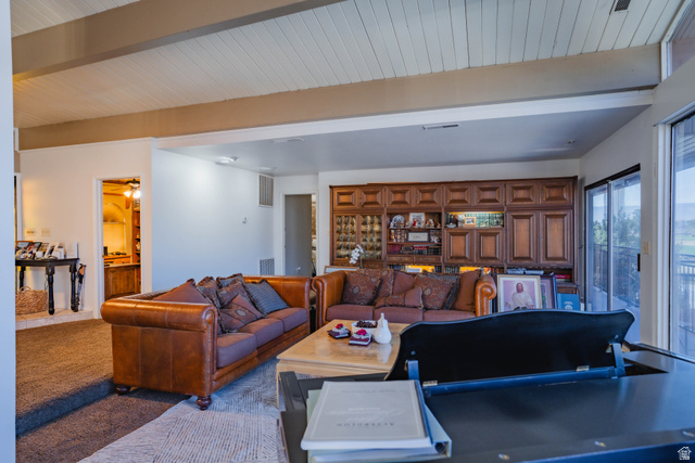 980 Cactus Circle St. George, UT 84790 - Photo 17 of 77 Living room with beam ceiling and carpet floors