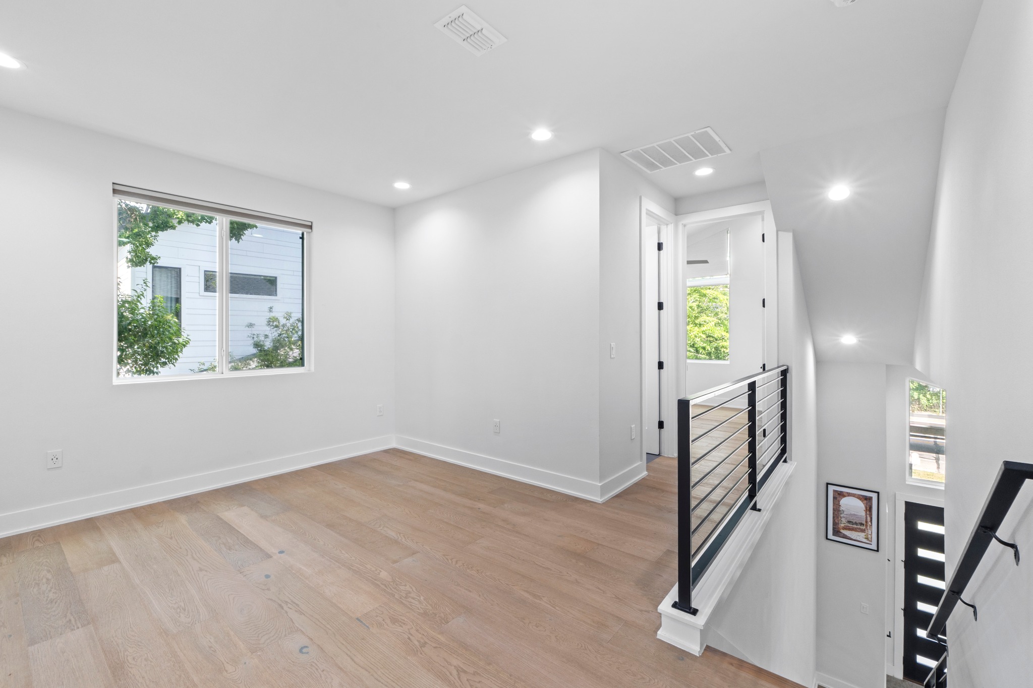 2007 Chestnut Avenue, Unit 1 Austin, TX 78722 - Photo 18 of 32 Clean lines define this bright loft space, boasting hardwood floors and contemporary railings.