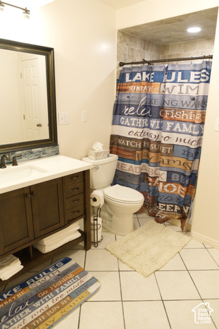 588 Raspberry Patch Road Garden City, UT 84028 - Photo 30 of 74 Full bathroom with vanity, light tile patterned floors, and a shower with curtain