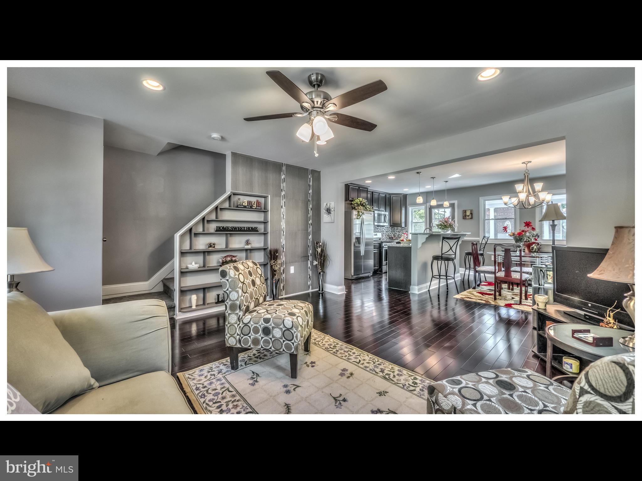 5932 Hillen Road Baltimore, MD 21239 - Photo 1 of 23 a view of a livingroom and dining room with wooden floor