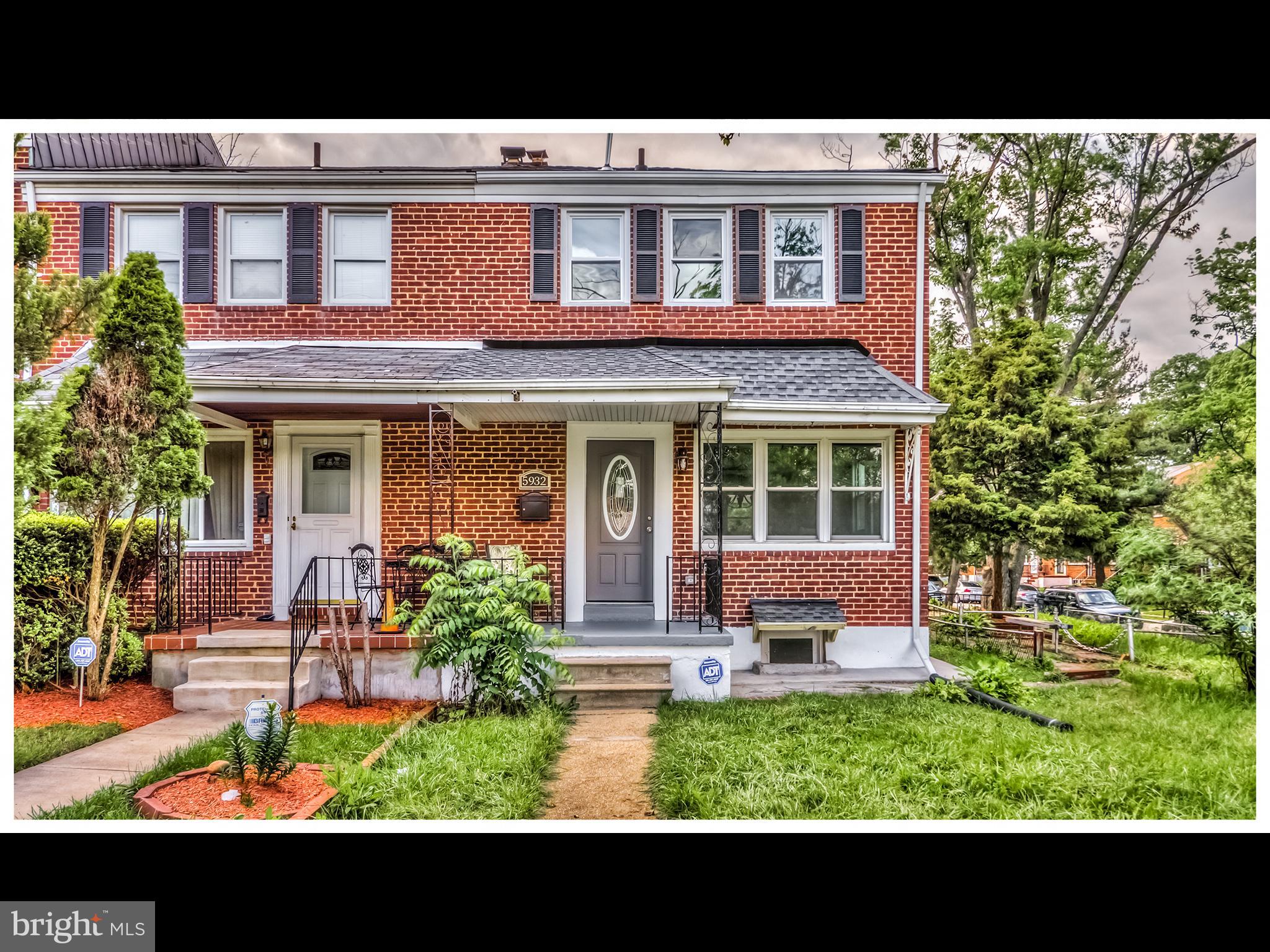 5932 Hillen Road Baltimore, MD 21239 - Photo 2 of 23 a view of a brick house with a yard and large tree