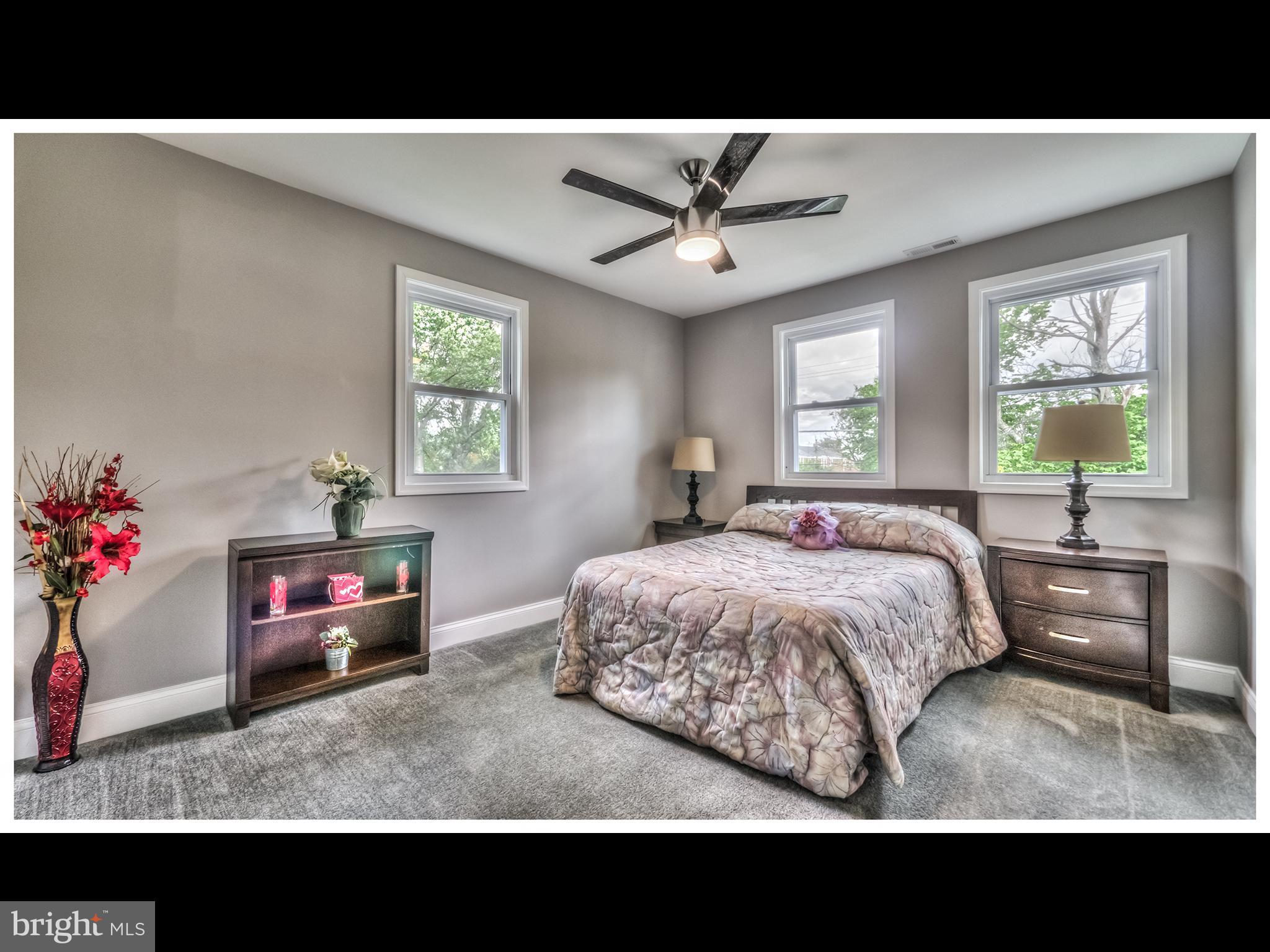 5932 Hillen Road Baltimore, MD 21239 - Photo 11 of 23 a living room with a bed furniture and a flat screen tv