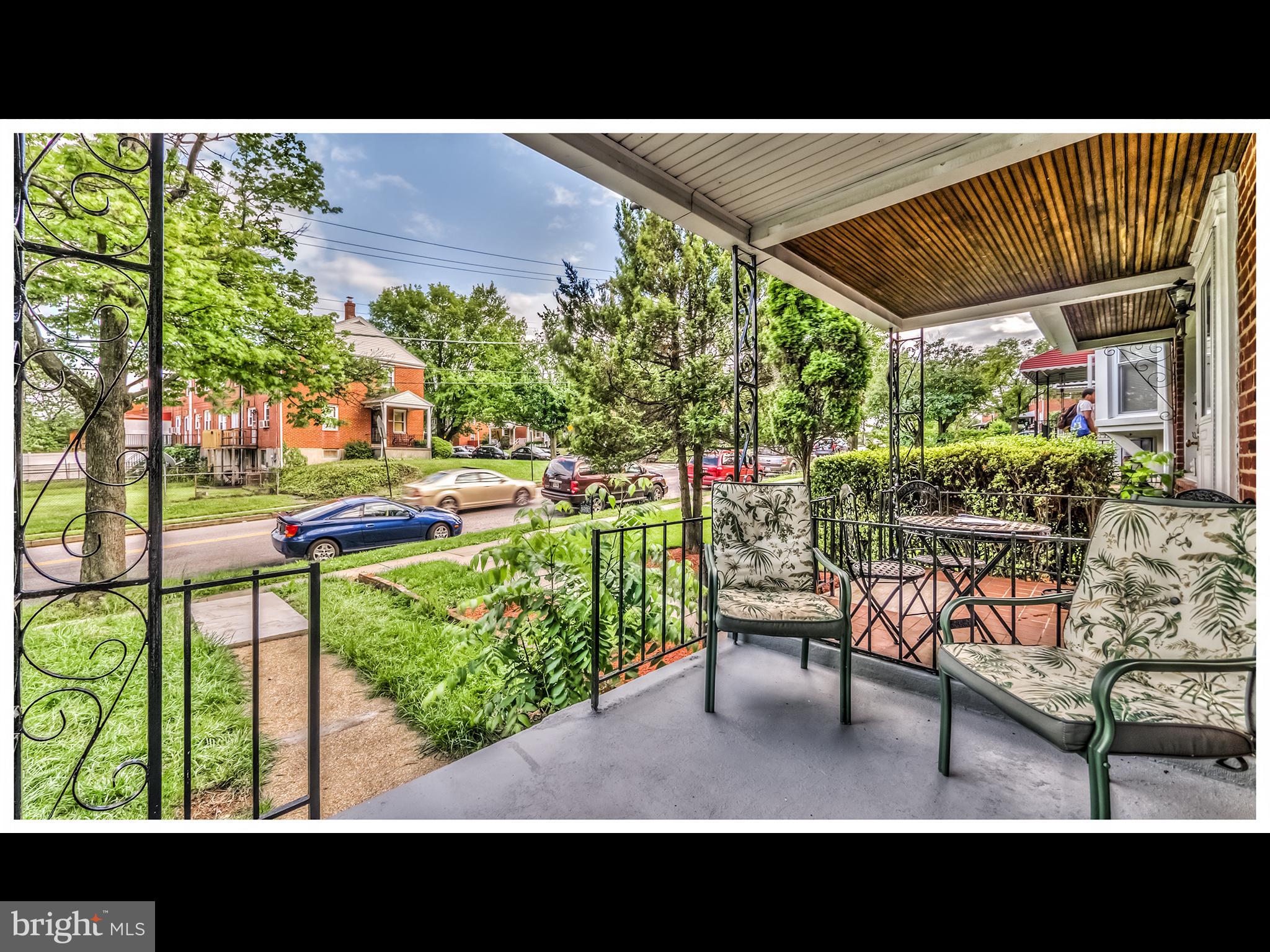 5932 Hillen Road Baltimore, MD 21239 - Photo 3 of 23 a view of an chairs and tables in the back yard of the house