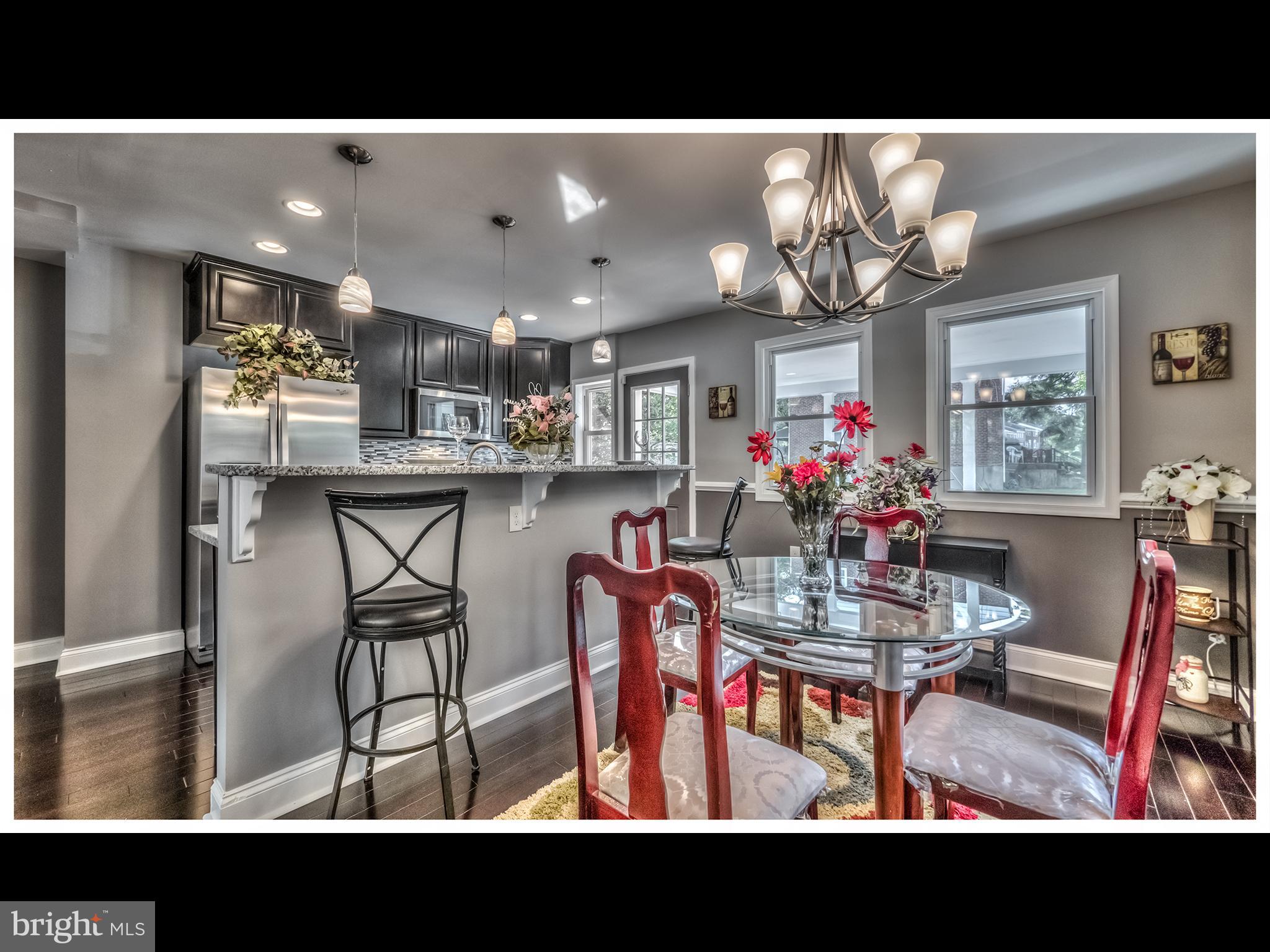 5932 Hillen Road Baltimore, MD 21239 - Photo 7 of 23 a view of a dining room with furniture and a chandelier
