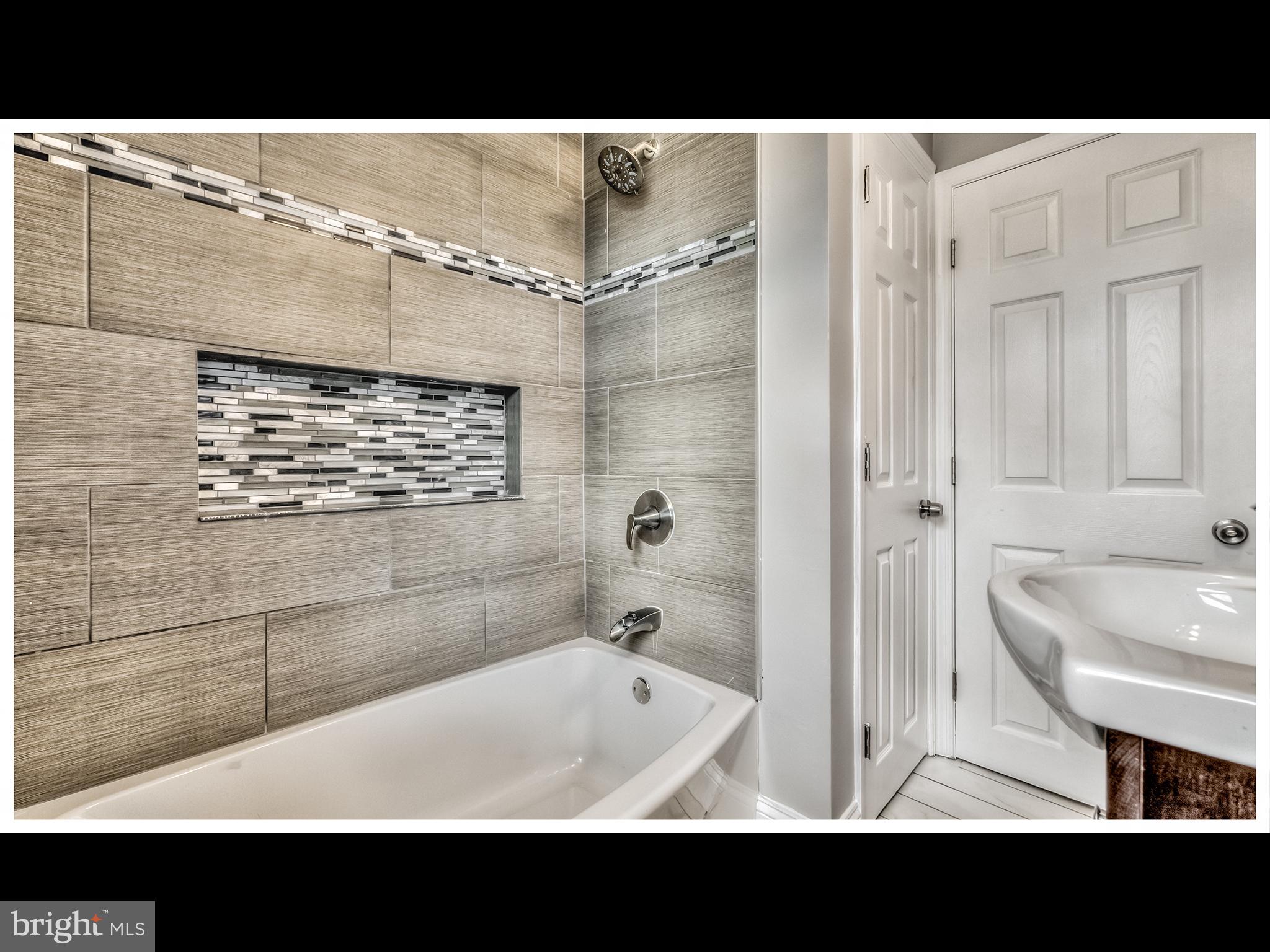 5932 Hillen Road Baltimore, MD 21239 - Photo 10 of 23 a view of bathroom with a sink bath tub and shower