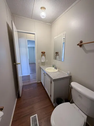 a bathroom with a sink a mirror and a toilet