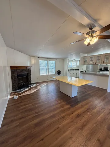 a living room with hard wood floors and a fireplace
