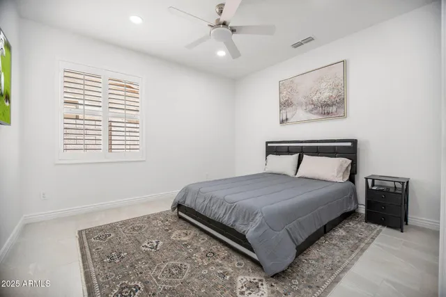 a bedroom with a bed and a couch