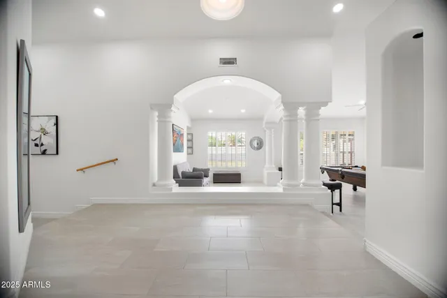 a view of a hallway with a large mirror and couches