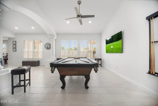 a room with furniture pool table and windows