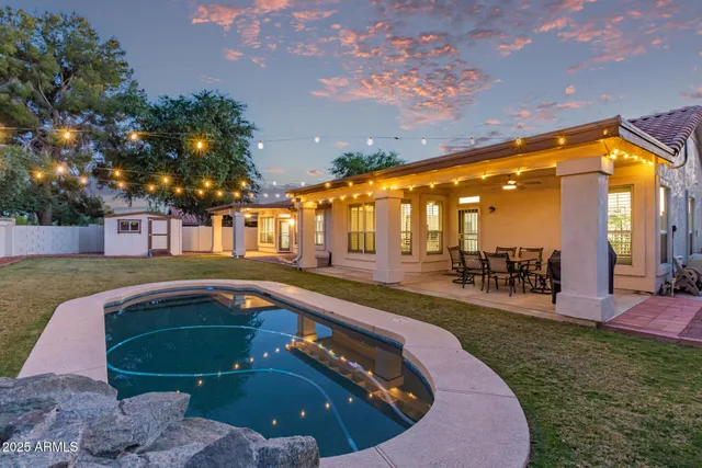 a swimming pool with outdoor seating and yard
