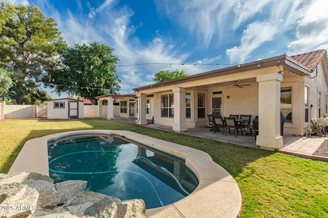 a view of swimming pool with outdoor seating