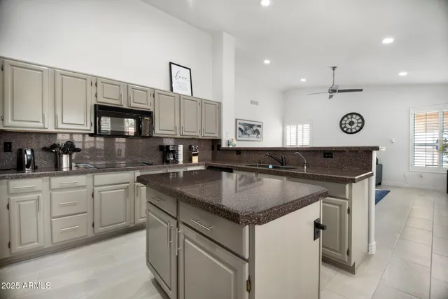 a kitchen with stainless steel appliances granite countertop a sink stove and cabinets