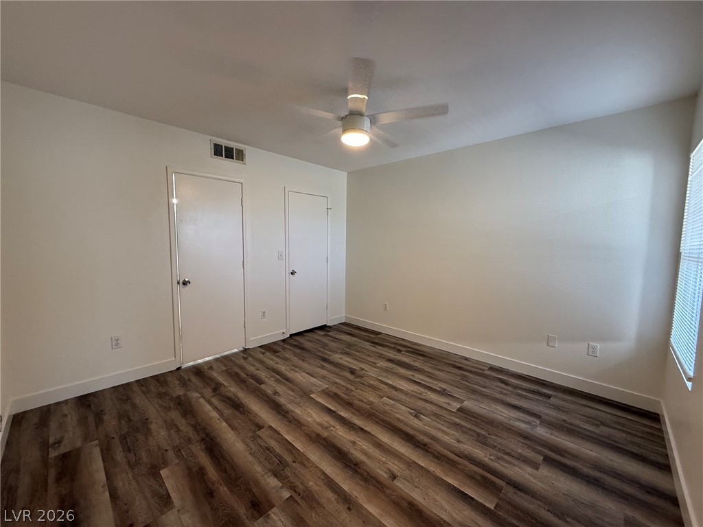 7255 West Sunset Road, Unit 2149 Las Vegas, NV 89113 - Photo 16 of 28 Well-lit room featuring durable wood-like flooring and ample natural light through window blinds.