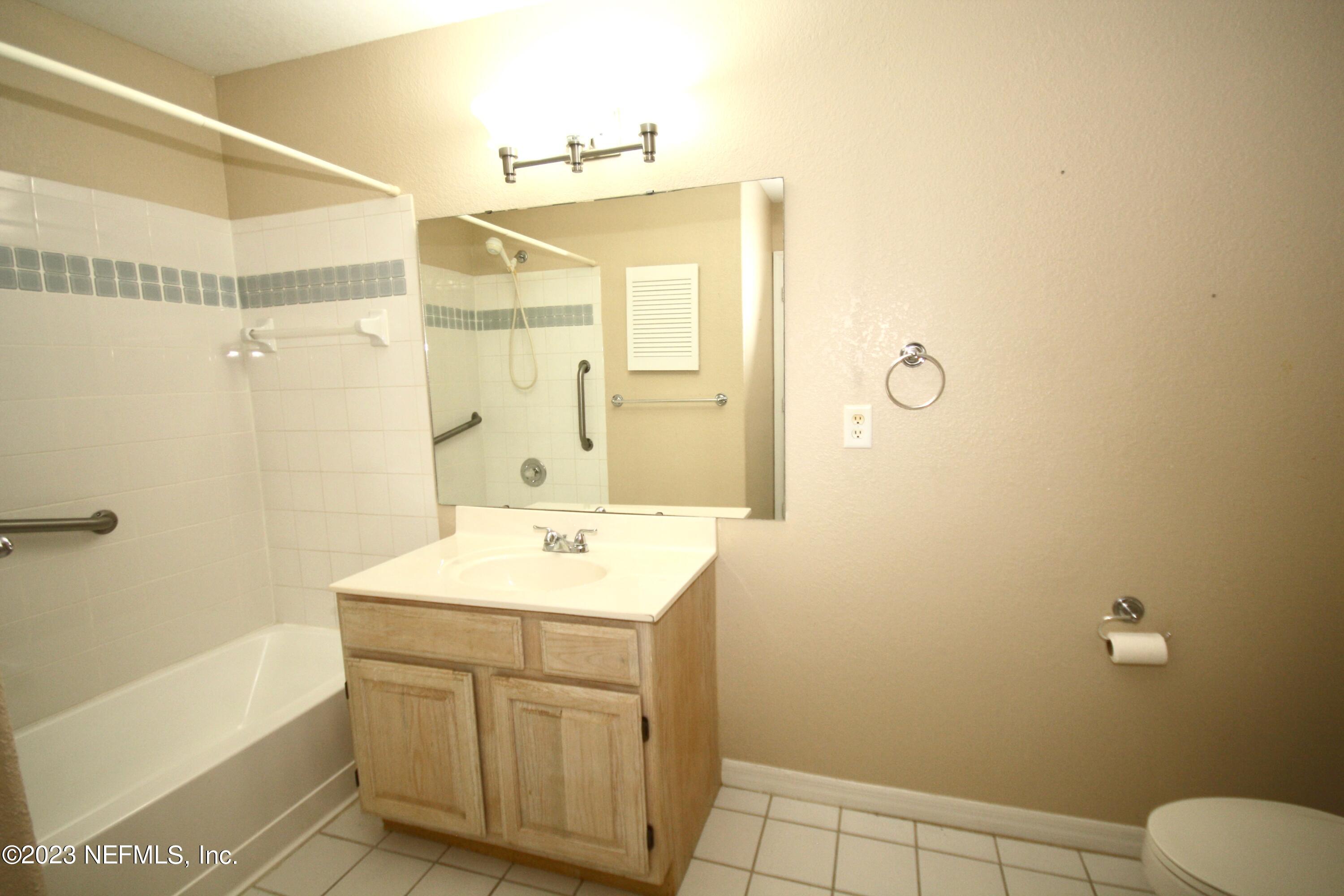 10150 Belle Rive Boulevard, Unit 2303 Jacksonville, FL 32256 - Photo 13 of 28 a bathroom with a sink a toilet and shower