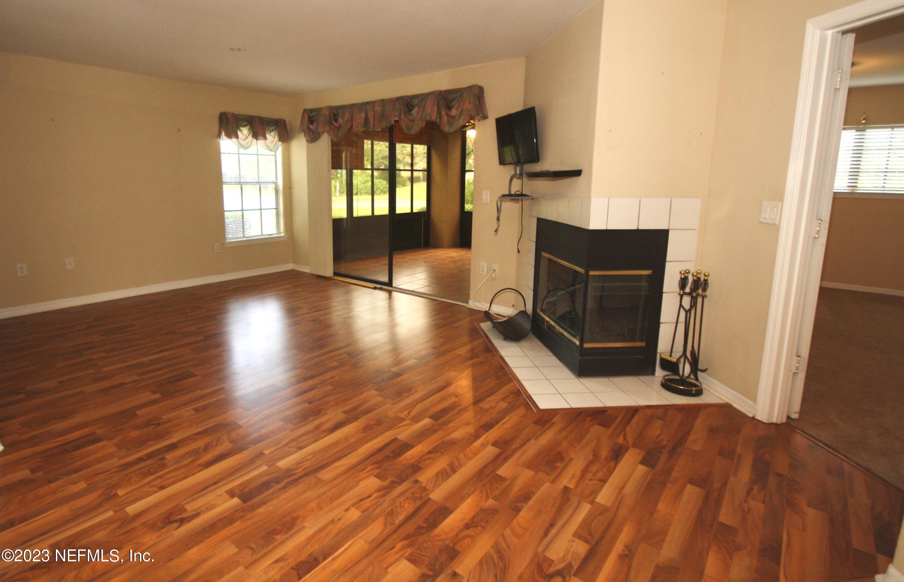 10150 Belle Rive Boulevard, Unit 2303 Jacksonville, FL 32256 - Photo 14 of 28 a view of an empty room with wooden floor and a window