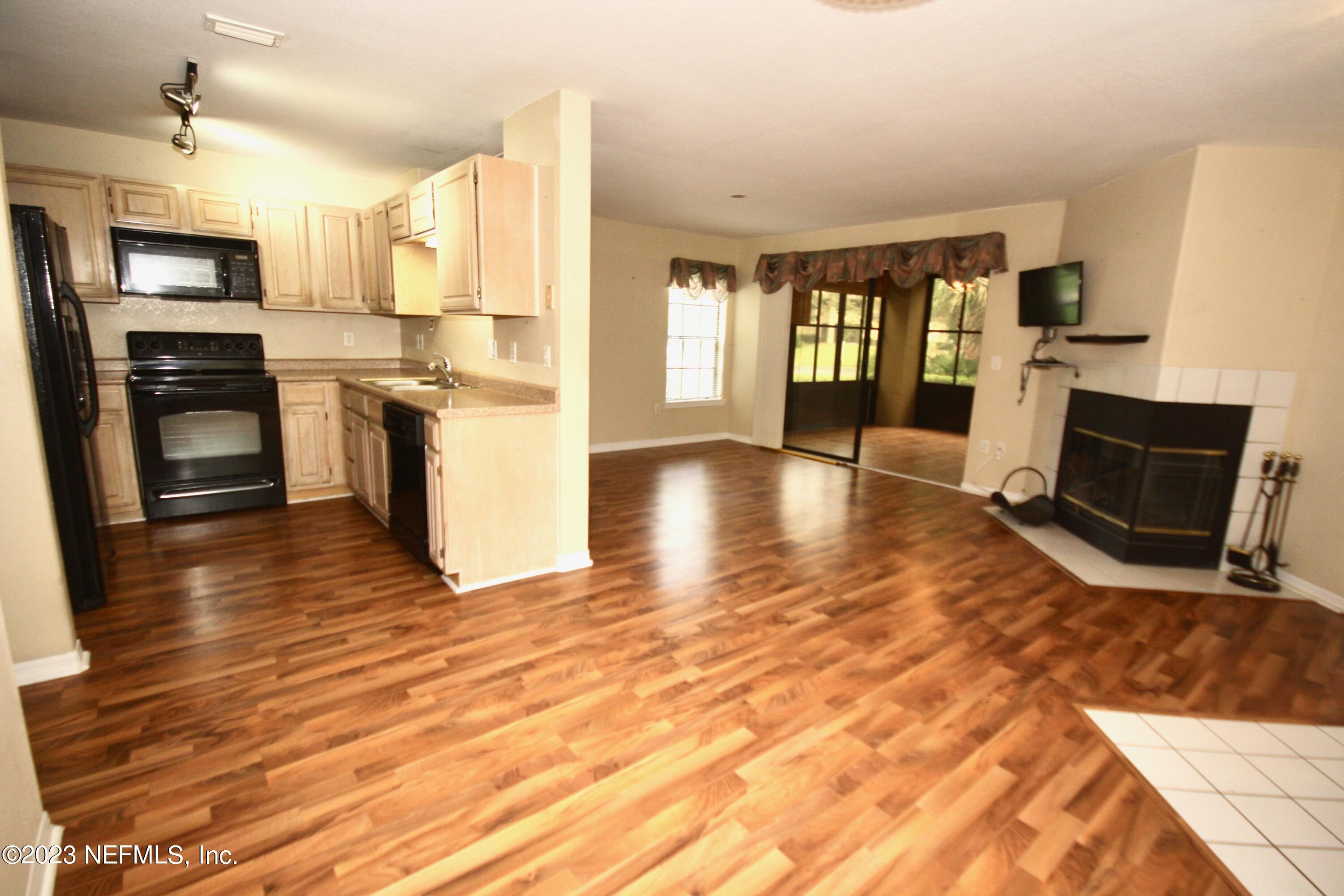 10150 Belle Rive Boulevard, Unit 2303 Jacksonville, FL 32256 - Photo 15 of 28 a view of kitchen with microwave a stove and furniture