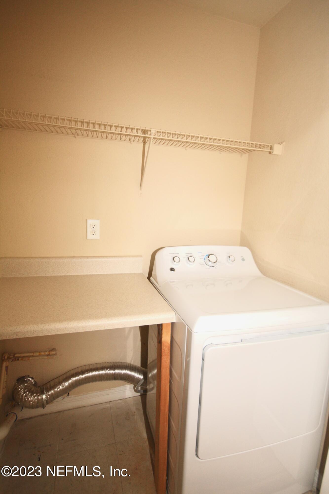 10150 Belle Rive Boulevard, Unit 2303 Jacksonville, FL 32256 - Photo 18 of 28 a utility room with dryer and washer