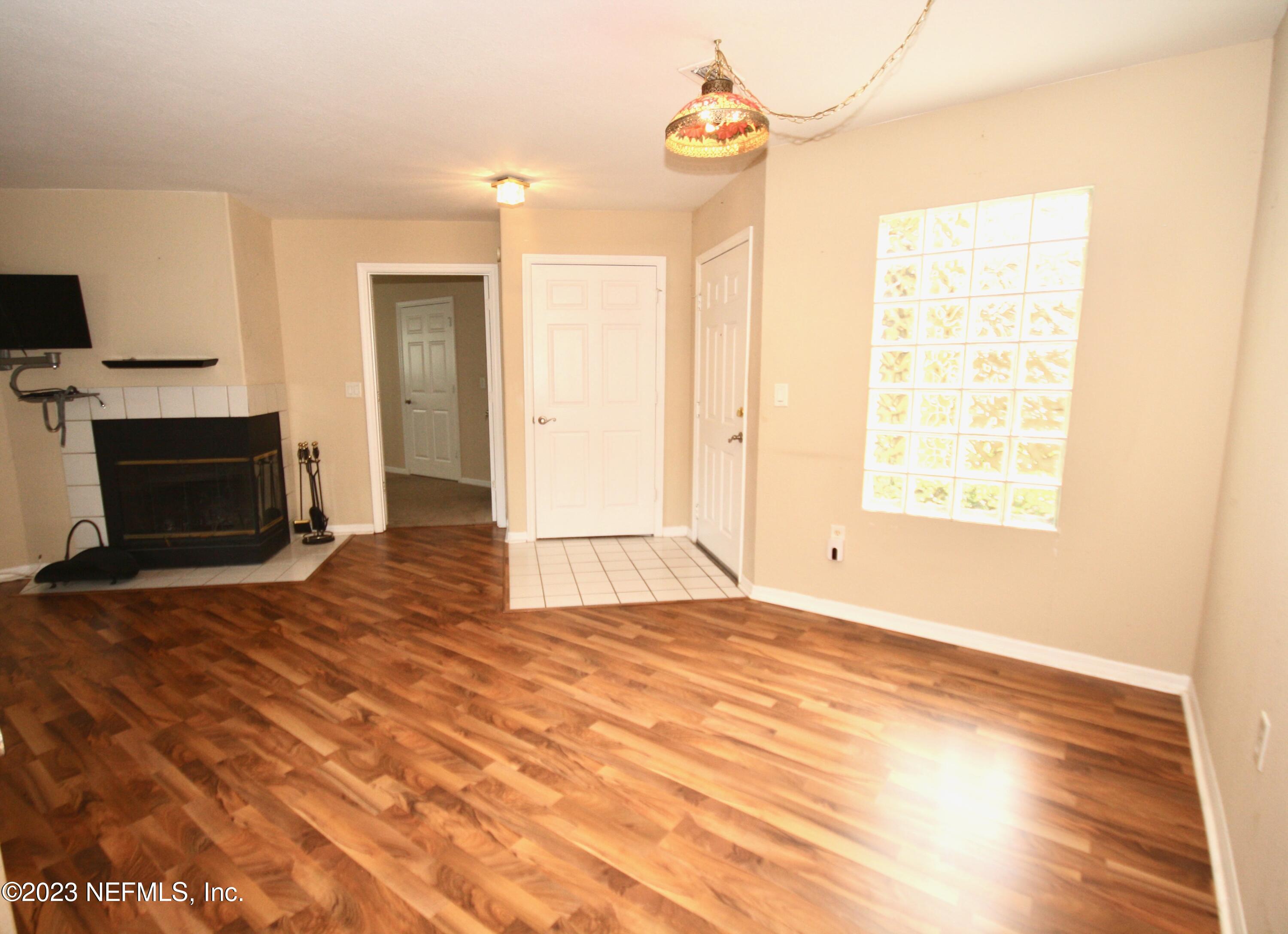 10150 Belle Rive Boulevard, Unit 2303 Jacksonville, FL 32256 - Photo 3 of 28 a view of an empty room with a fireplace and a window