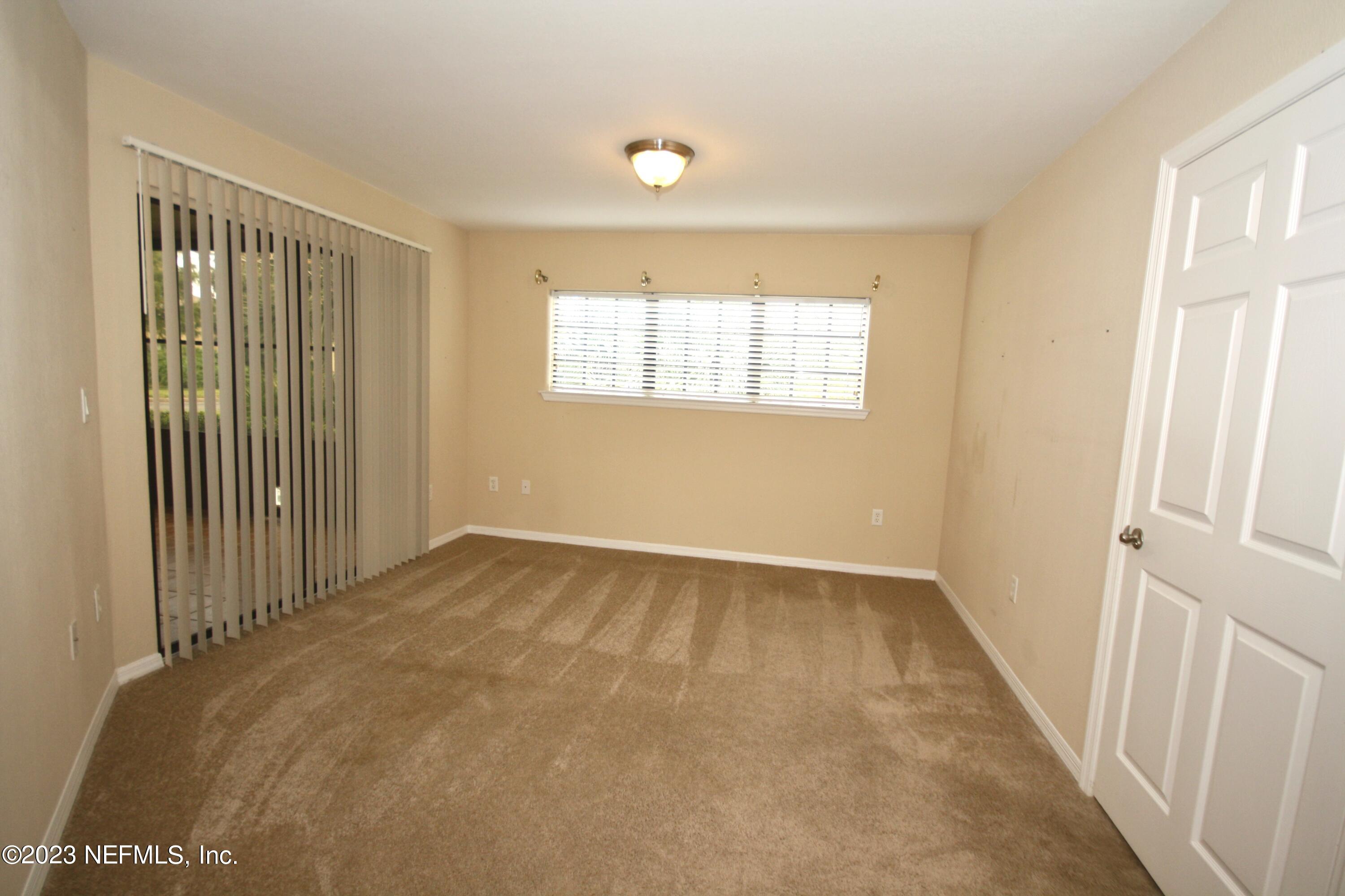 10150 Belle Rive Boulevard, Unit 2303 Jacksonville, FL 32256 - Photo 7 of 28 an empty room with windows